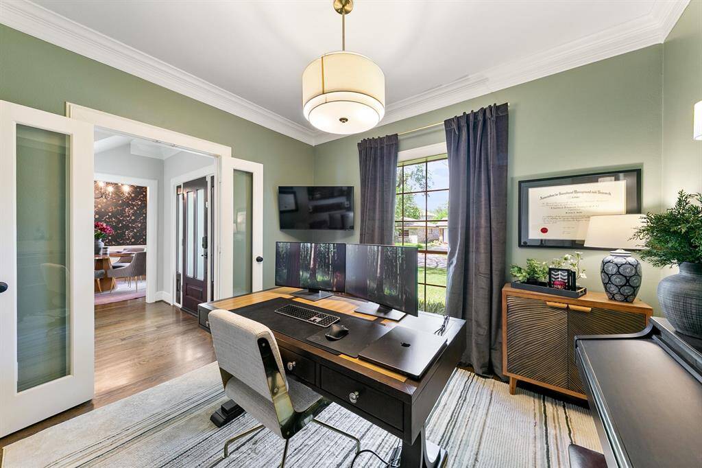 This angle of the room shows the double doors that you can close for privacy and the large front window that lets the natural light stream into the room.