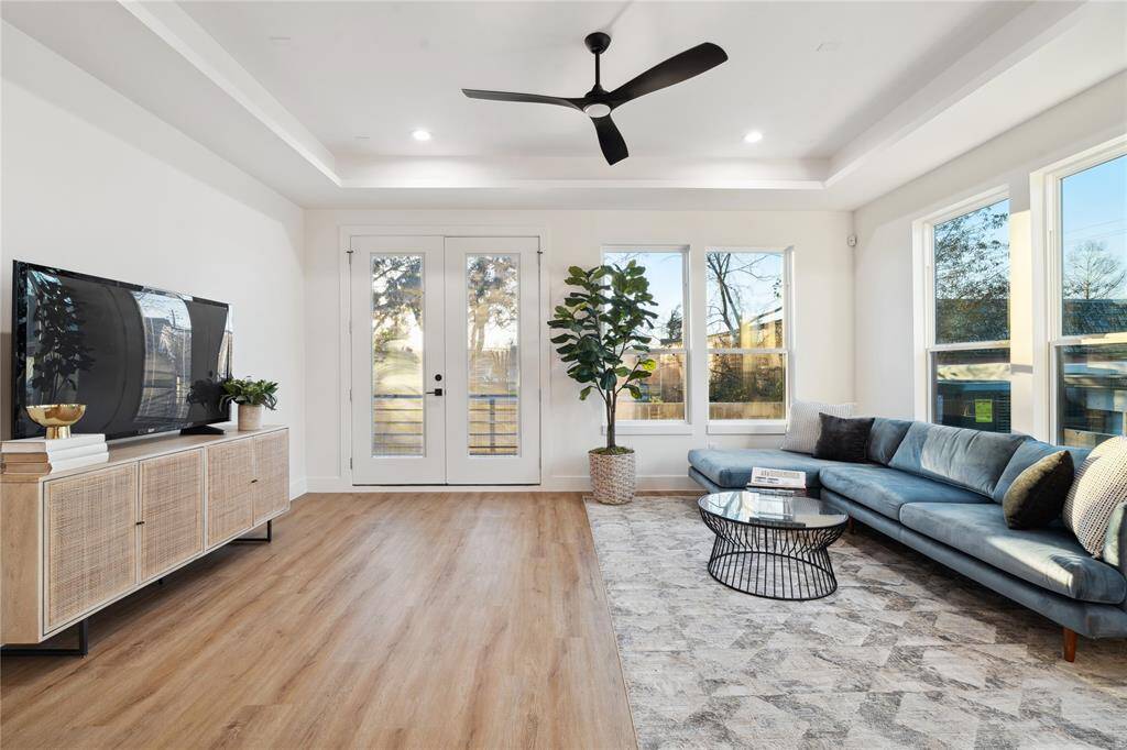 The french doors open to your backyard space lined with artificial turf while aligned with an array of windows.