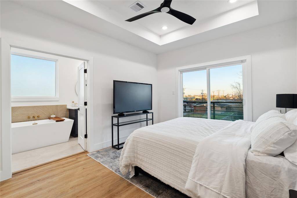 The primary bedroom give a nice reveal of the primary ensuite while displaying a modern style tray ceiling.