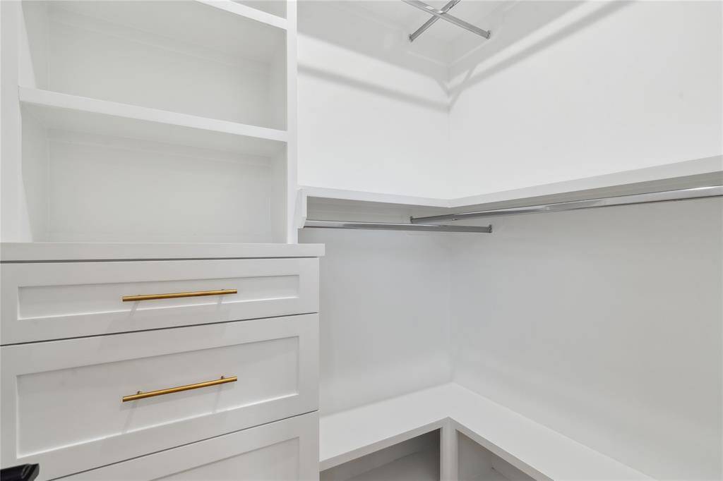 The secondary walk in closet stays in line with the luxury feel of the primary closet.