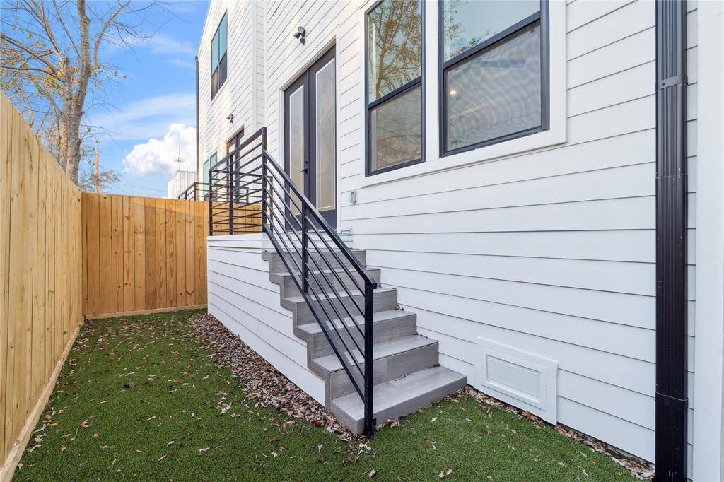 The backyard embodies the concept of low maintenance and is also pet friendly with artificial turf.