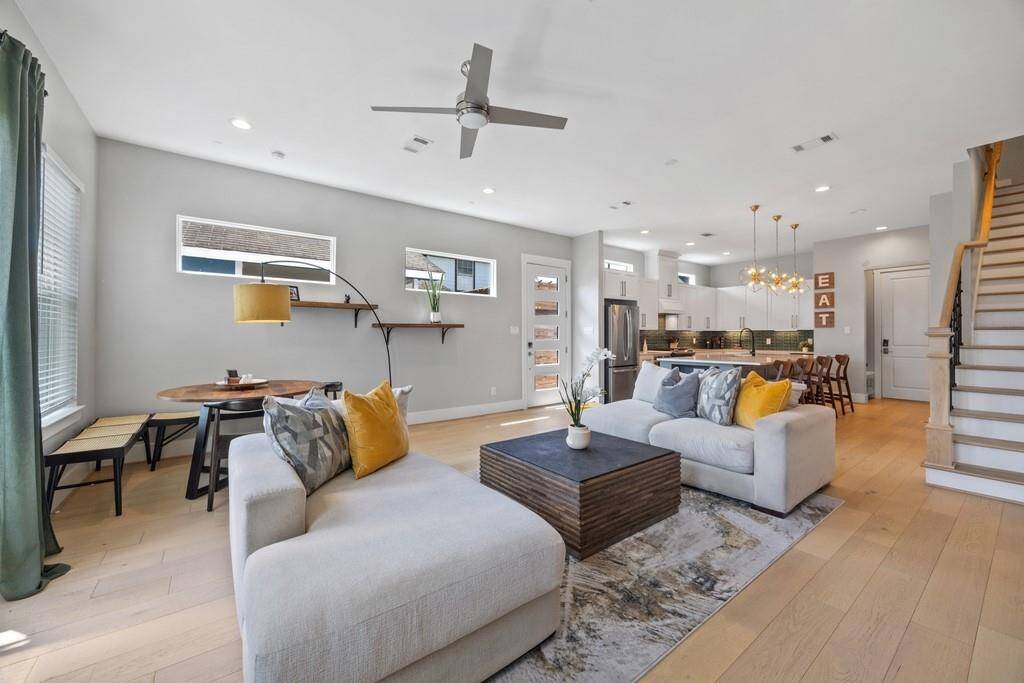 Spacious open-concept living room with modern finishes, natural light, and seamless flow into the kitchen and dining area. Available fully furnished or unfurnished.