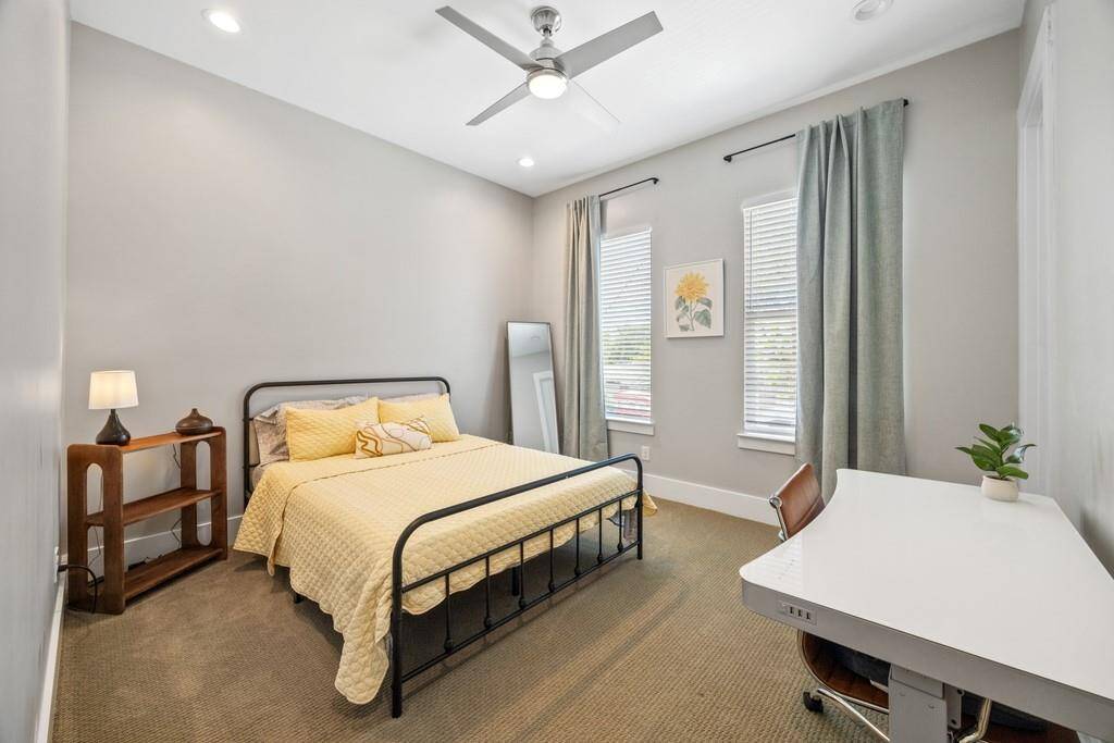 Charming guest bedroom with soft natural lighting and plenty of space.