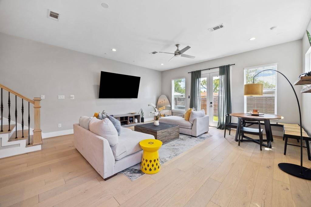 Elegant living and dining space with large windows, recessed lighting, and sophisticated design perfect for entertaining.