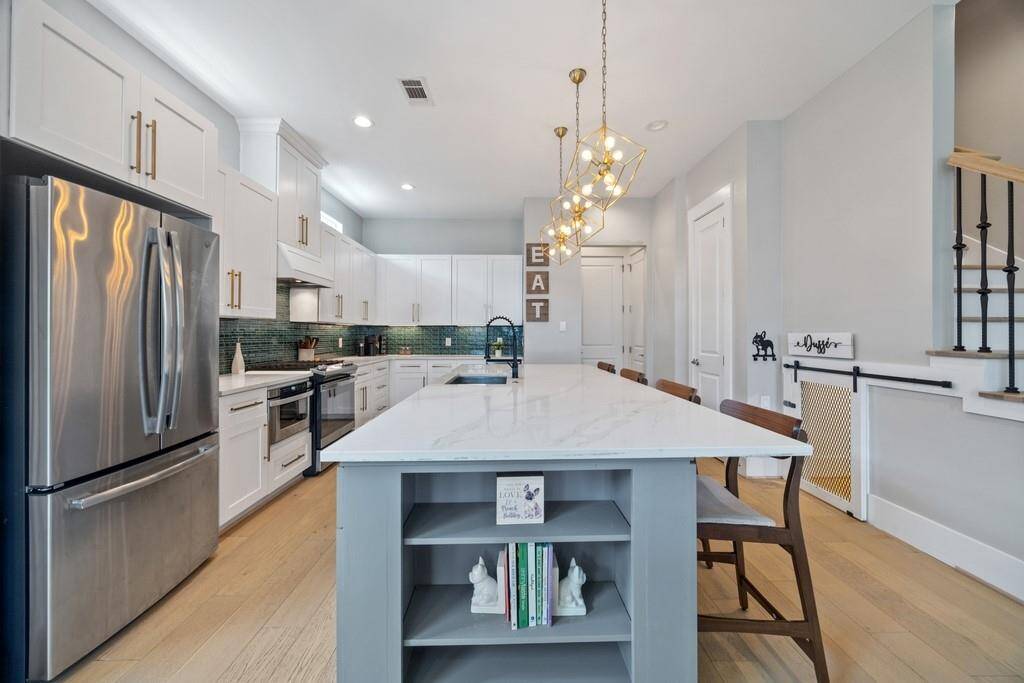 Chef’s kitchen with stainless steel appliances, expansive counter space, and a functional layout.