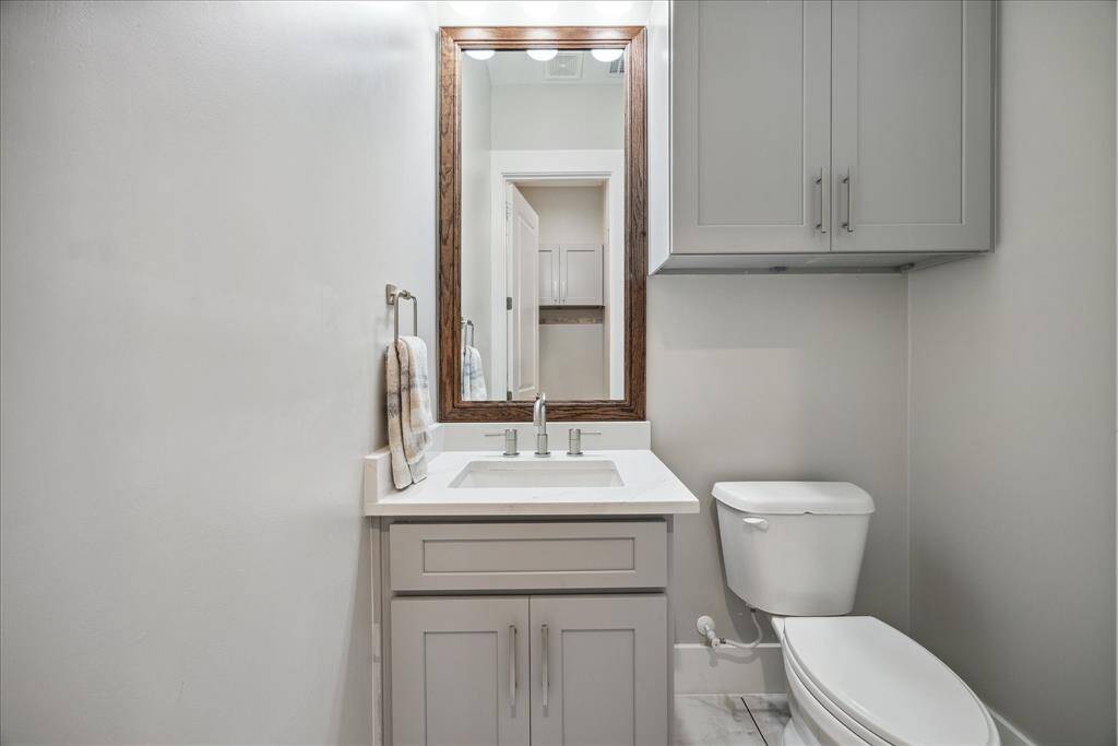 Stylish half powder room with modern vanity and minimalist design.