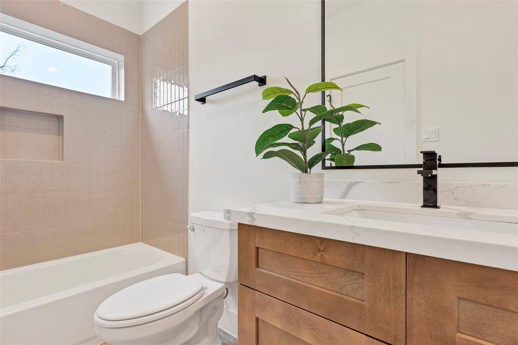 Convenient en-suite bathroom on the first floor, featuring a tub and shower combo along with a single sink for comfort and practicality.