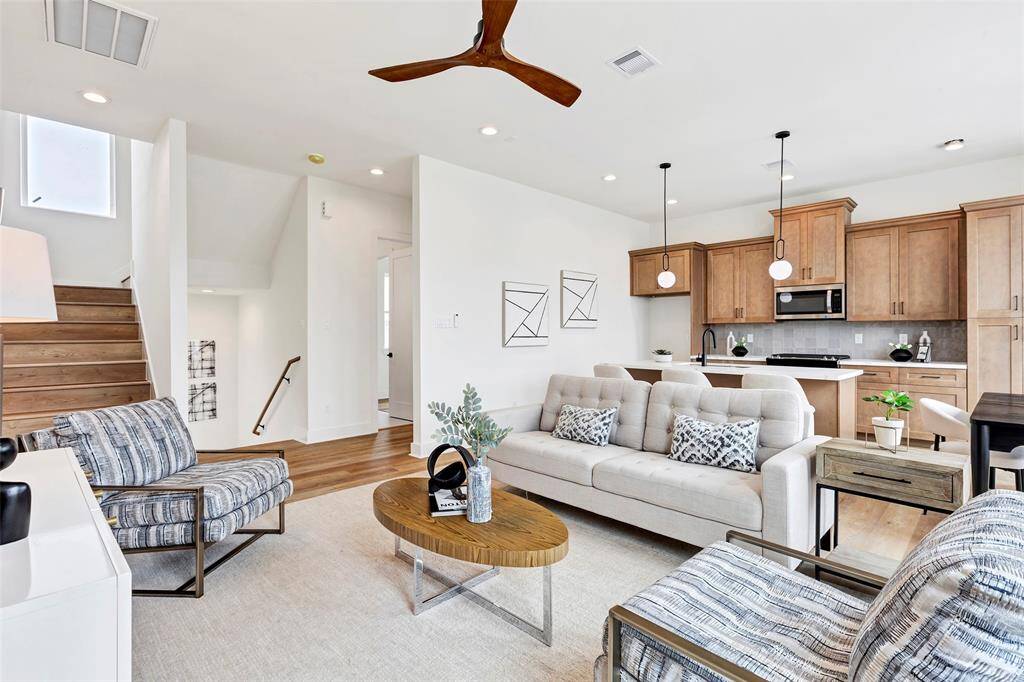 Seamlessly connected living room with a glimpse of the kitchen at the back.