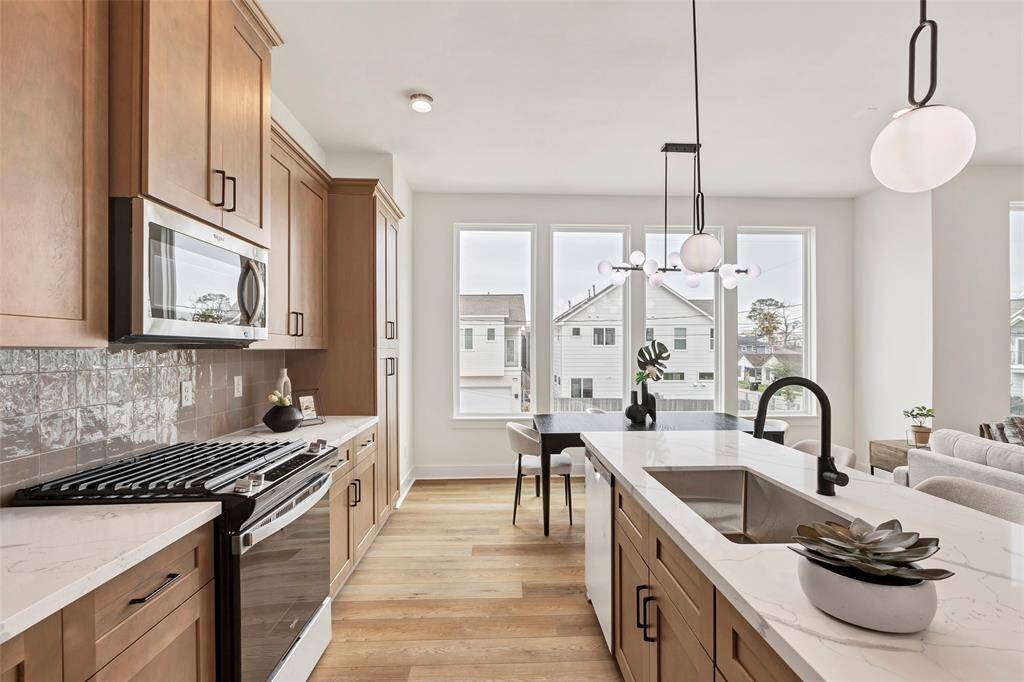 This modern kitchen equipped with sleek, high-end appliances, perfect for cooking and entertaining with ease.