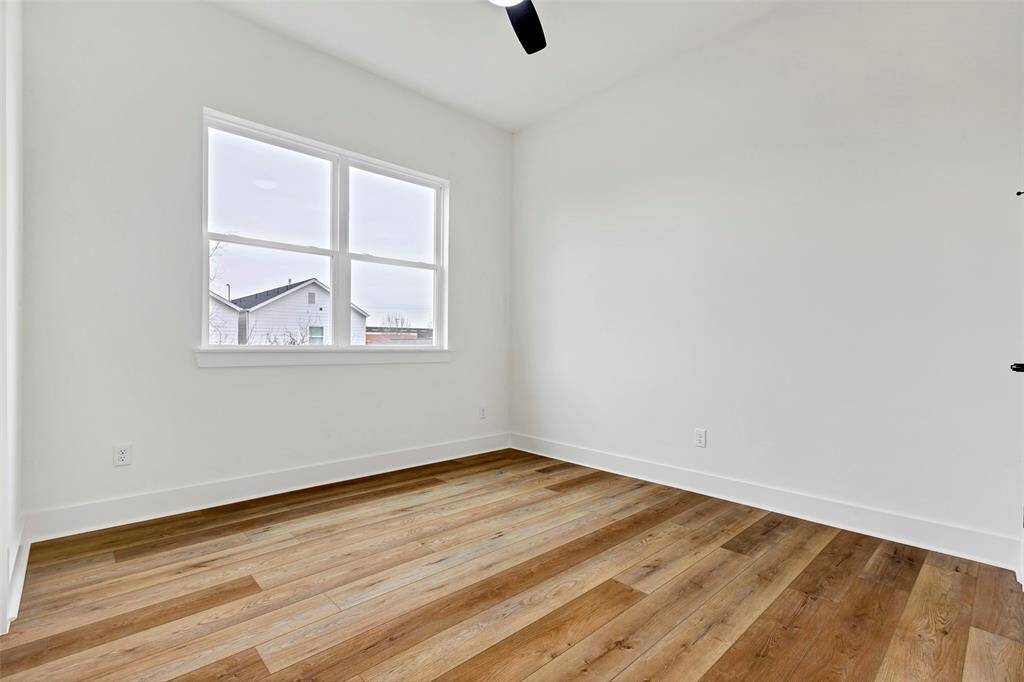 Cozy secondary bedroom on the second floor, featuring beautiful wood floors that add warmth and character to the space.