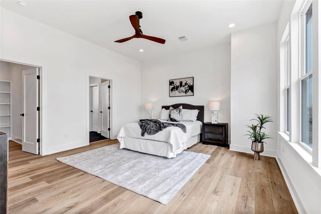 Conveniently located next to the bed, one door leads to the main bath, while the other opens to a spacious walk-in closet – offering both comfort and functionality.