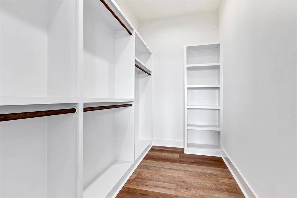Spacious walk-in closet offering ample storage for all your personal items, keeping everything organized and easily accessible.