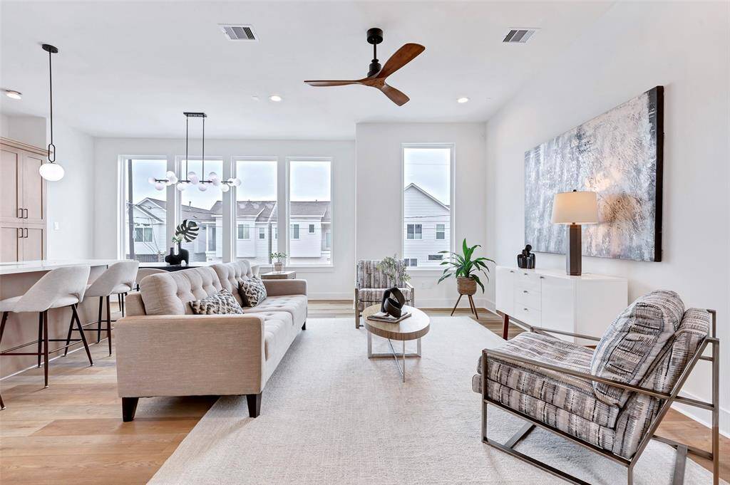 Bright and airy living room with expansive glass windows that flood the space with natural light.