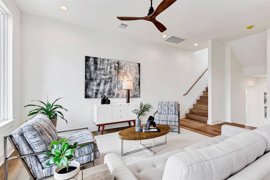 Another view of the inviting living room, with a peek at the staircase leading up to the third floor.