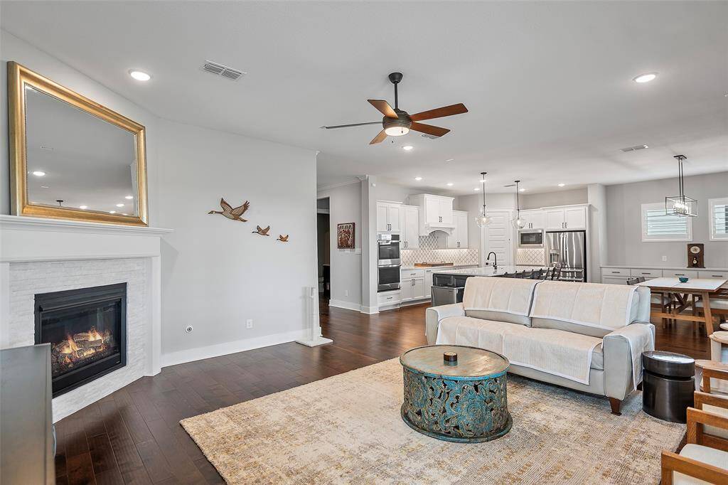 A corner fireplace with gas connections and custom wood mantel is sure to warm the hearts of everyone that gathers here!