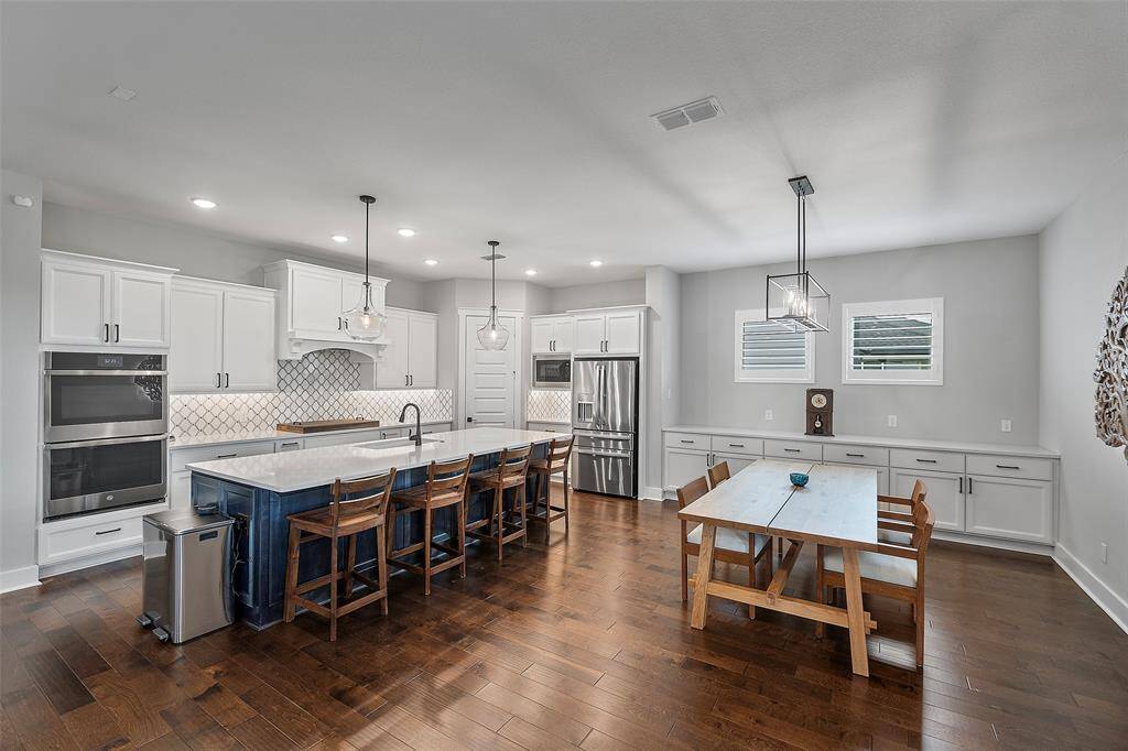 This is a very SPACIOUS entertaining space! This room boasts a large accent color island providing additional seating & storage, along with the buffet style space tucked behind the dining area!