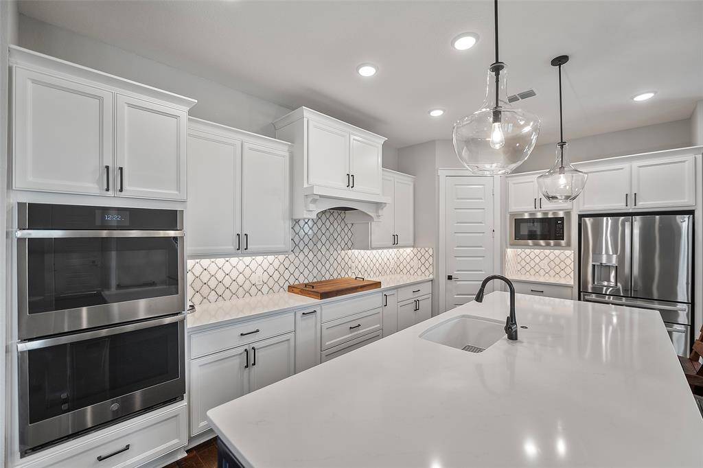 So much lighting, from the undermount cabinet lighting to the pendants to the recessed lighting above, every task will be shown upon! And the sparkling stainless appliances include a built-in microwave, space for the refrigerator, double ovens (single convection) and a 4-burner gas up-draft cooktop!