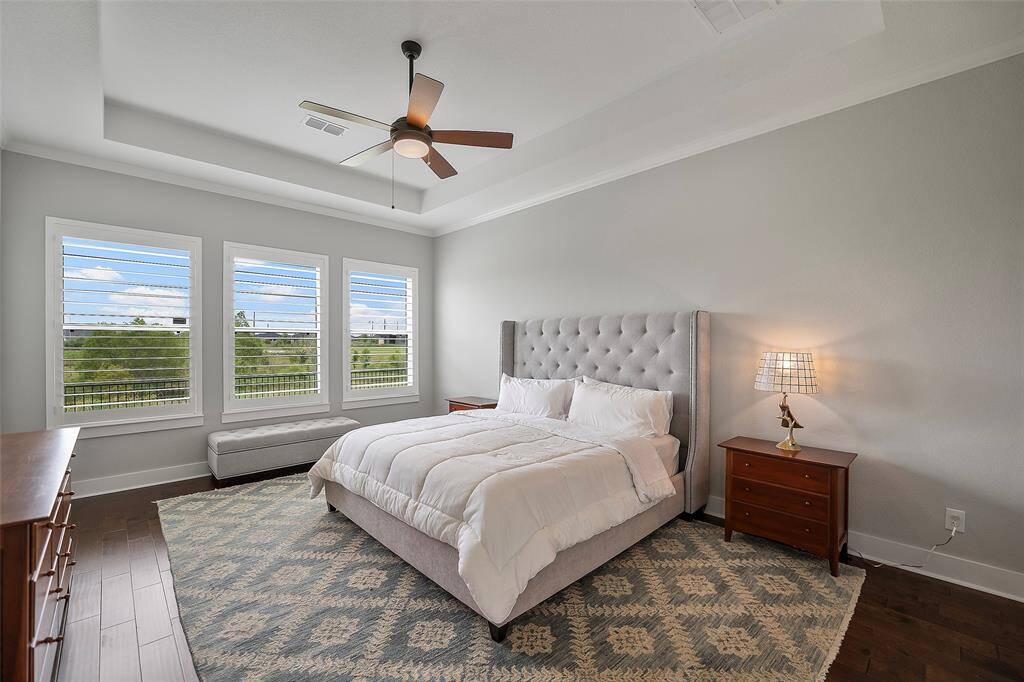 A peaceful primary suite awaits you to enjoy a quiet afternoon nap, or an evening of pure rest! A tray ceiling with neutral tones and Plantation shutters to control amazing natural light is all you need!