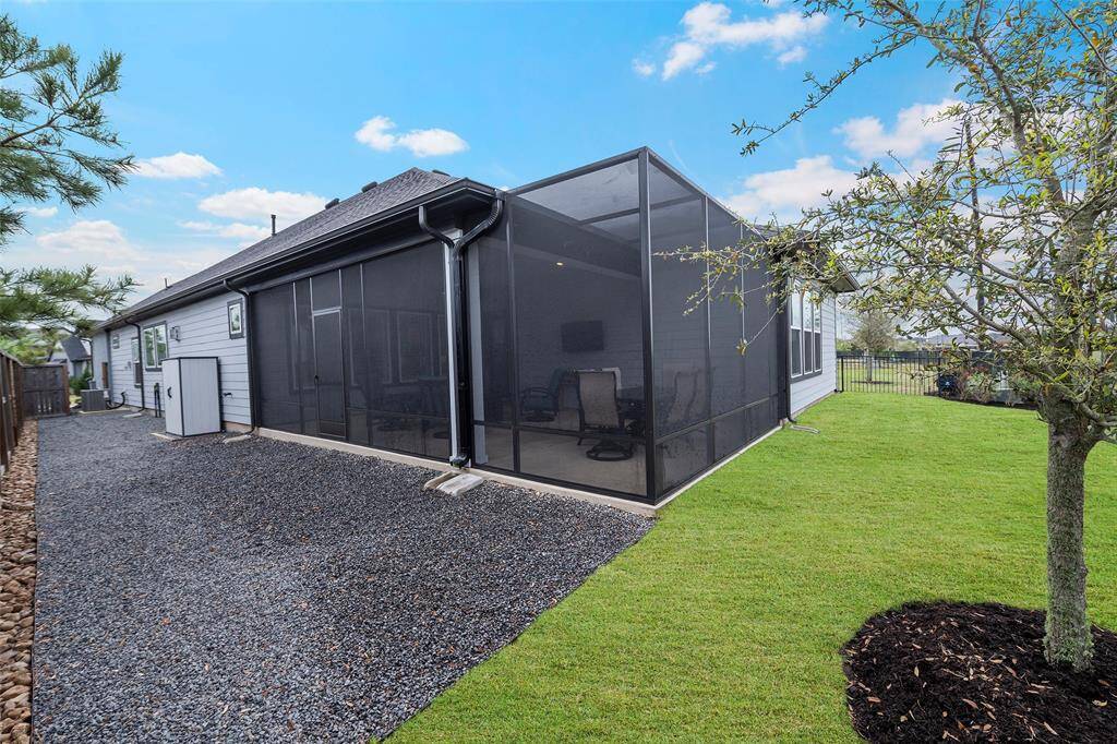 A powered awning helps control the amount of sun that flows into the space, and for added privacy! Black star gravel has been placed on the side yards, keeping everything looking sharp and clean!