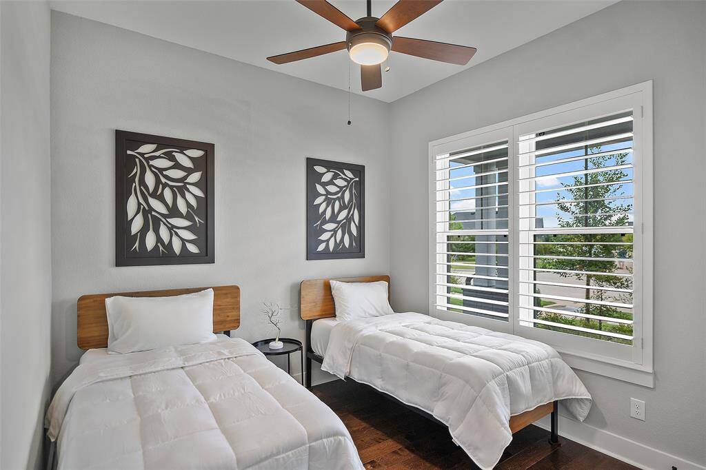 Around the corner, you will find this serene secondary bedroom with views! Just once tug of the Plantation shutters and this room becomes a haven for a peaceful evening's sleep!