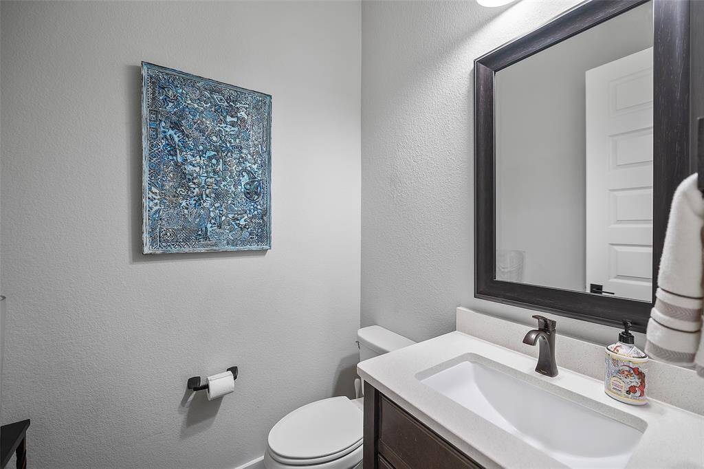 A quaint powder room stands ready for guests to freshen up during their visit!