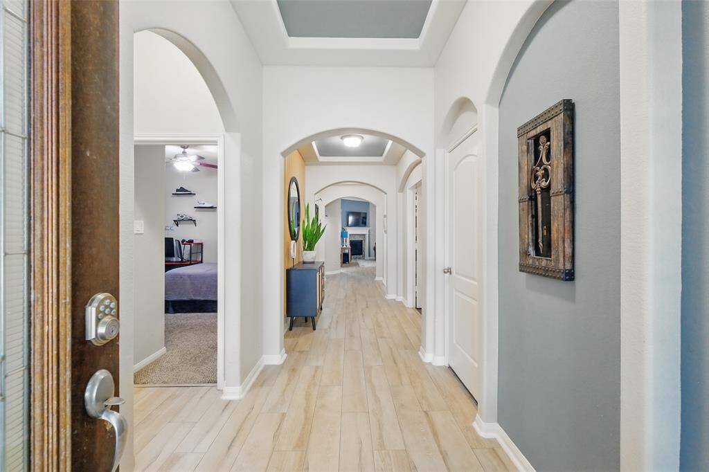 Time to explore inside. The entry way greets you with custom paint, trey ceilings, and newly installed wood looking tile floors.
