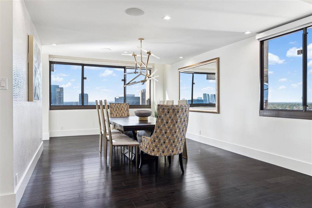 Dining room with expansive windows offering stunning views of the north and west. Equipped with window shades, though the views are too good to cover!