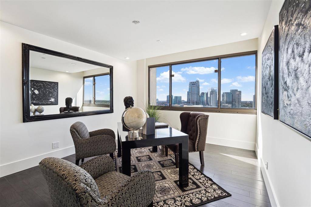 One of two secondary bedrooms, currently styled as a home office. Features new engineered hardwood floors, modern recessed lighting, fresh paint, a spacious storage closet, and beautiful views.