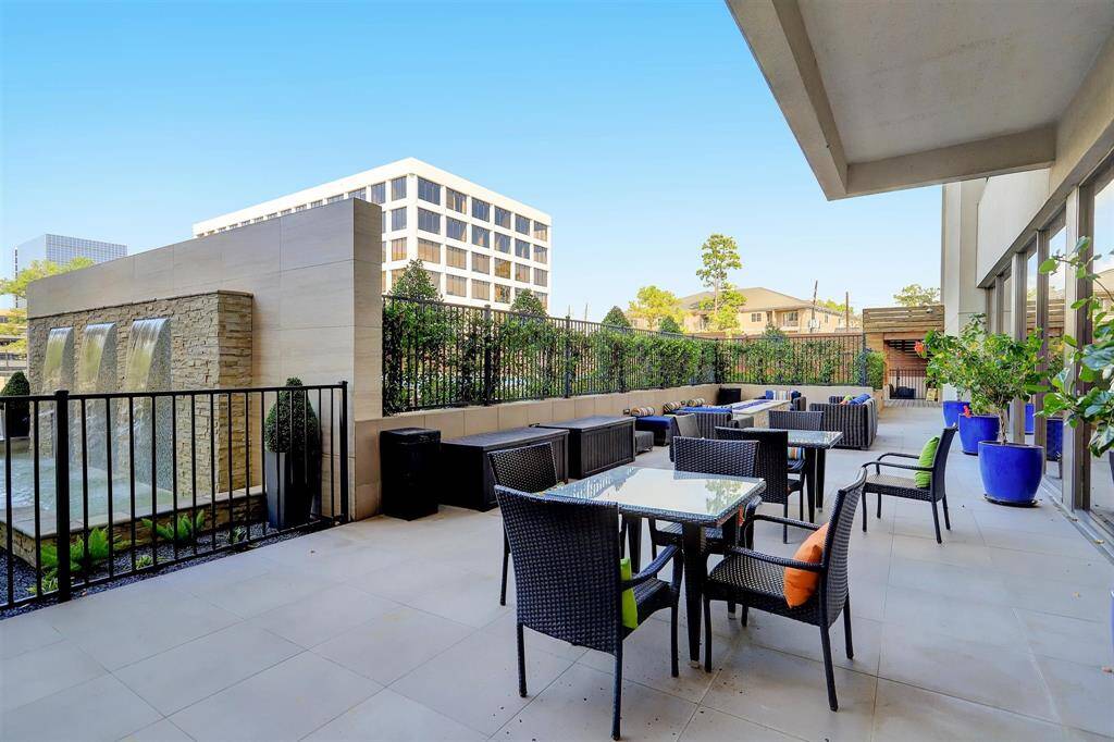 The building features amenities perfect for entertaining, including a firepit, poolside grilling area, and a spacious terrace for outdoor dining with guests.