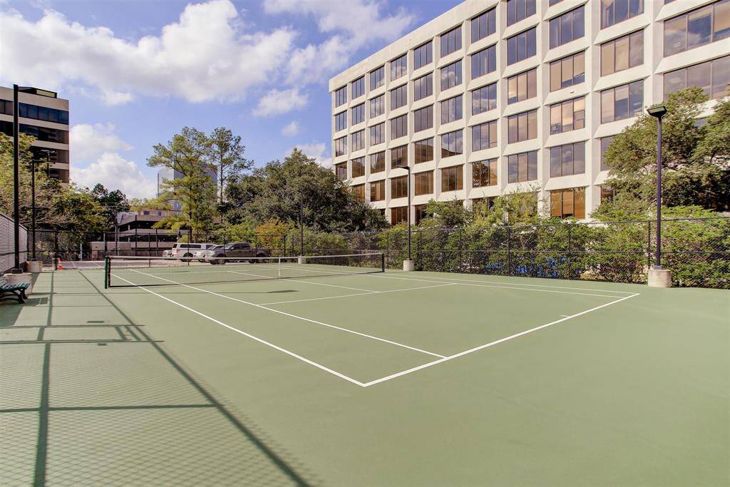 Building sits on over 2 acres- which includes a full tennis court with lights.