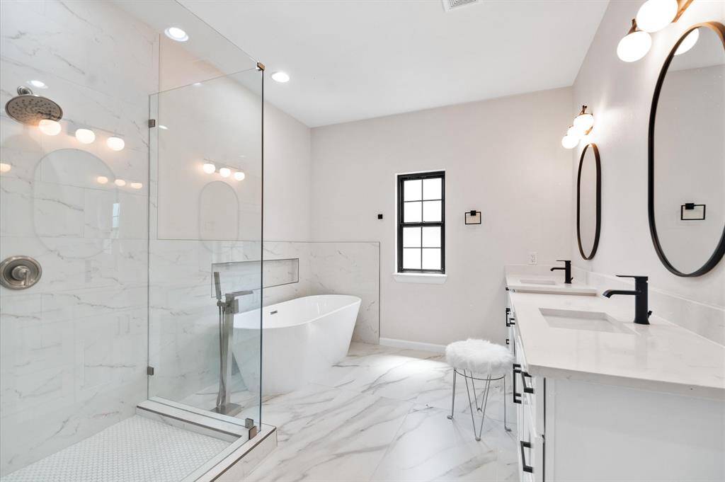 Master bath with oversized shower, vanity, 2 sinks, tile flooring, Roman tub and more.