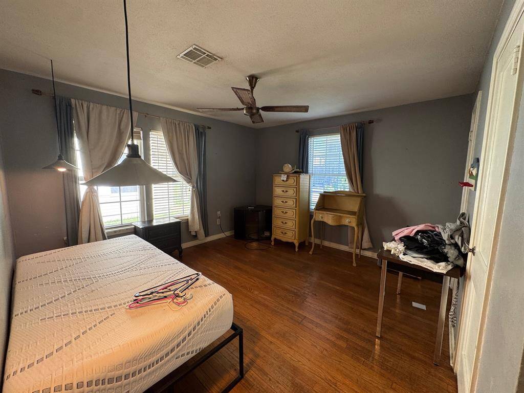 Secondary bedroom 1 with original hardwood flooring