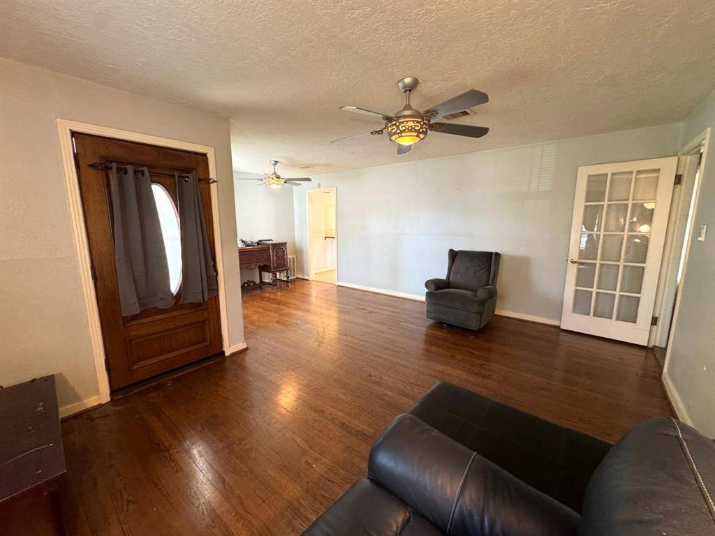 From corner of living room showing front door on the left and dining in rear
