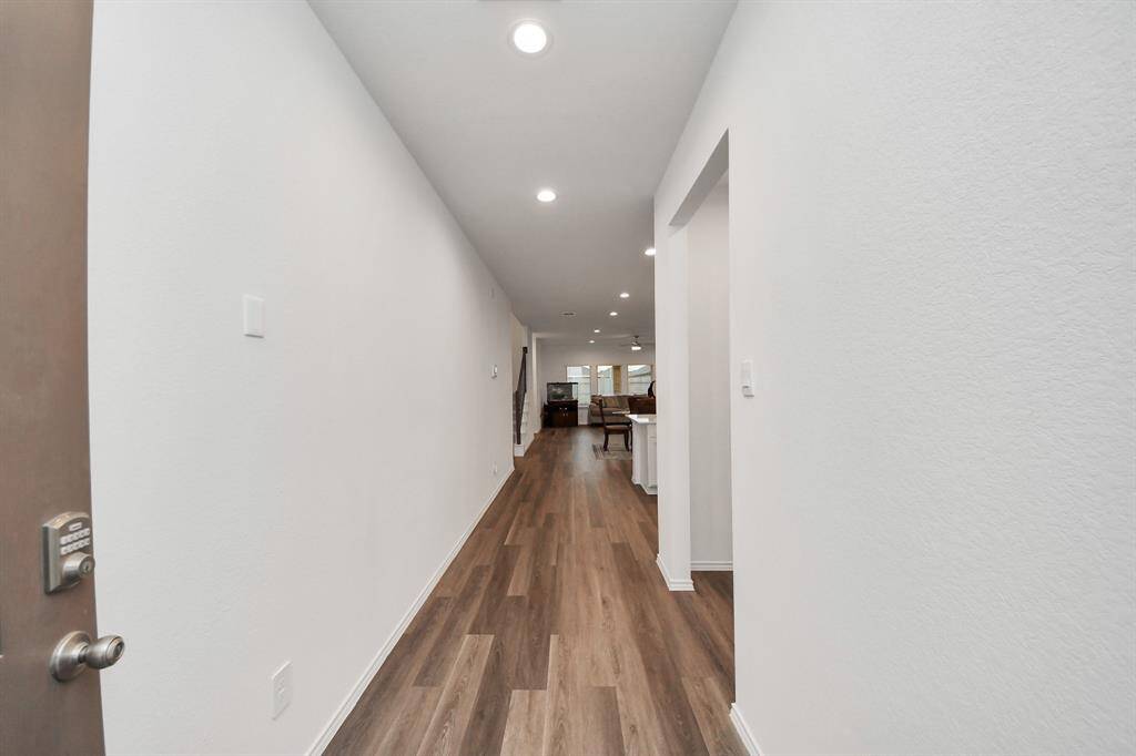 Welcome home to a bright, inviting foyer leading seamlessly into the spacious living area, featuring elegant flooring and modern lighting.