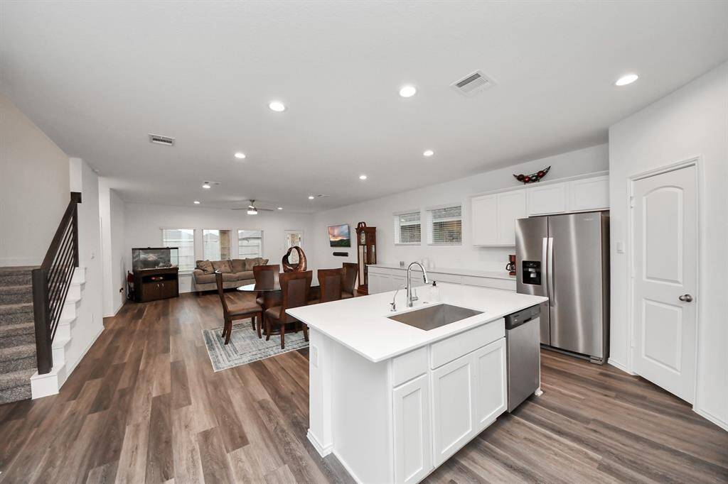 This spacious kitchen seamlessly flows into the dining area and family room, perfect for entertaining and family gatherings.