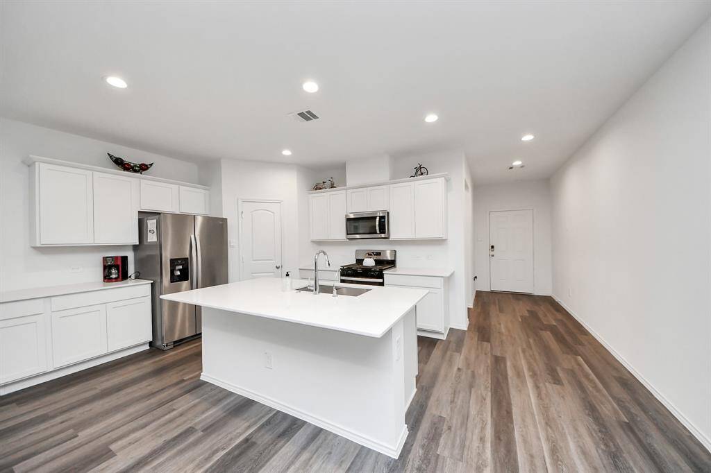 view of kitchen from dinning area towards the front door