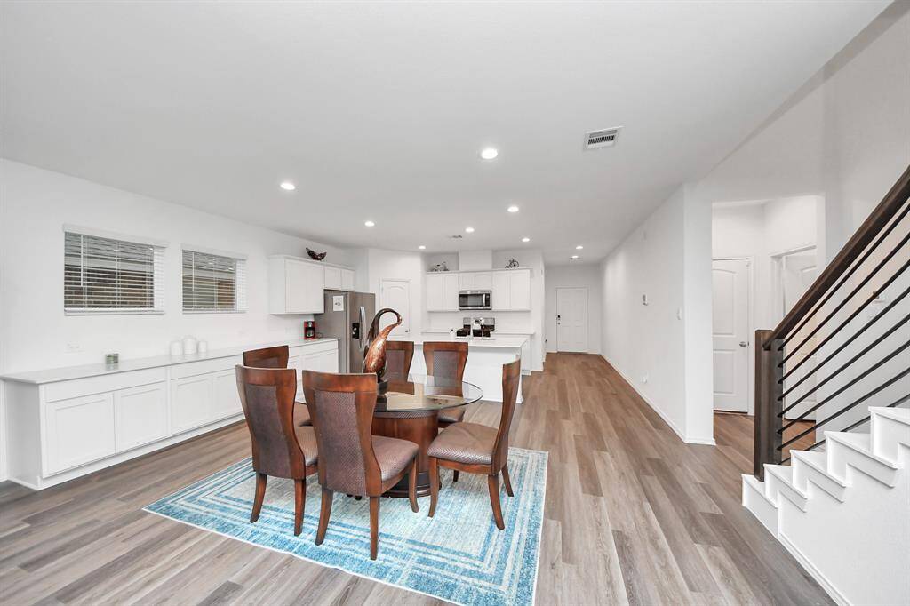 Spacious dining area with sleek quartz countertops and ample cabinetry.