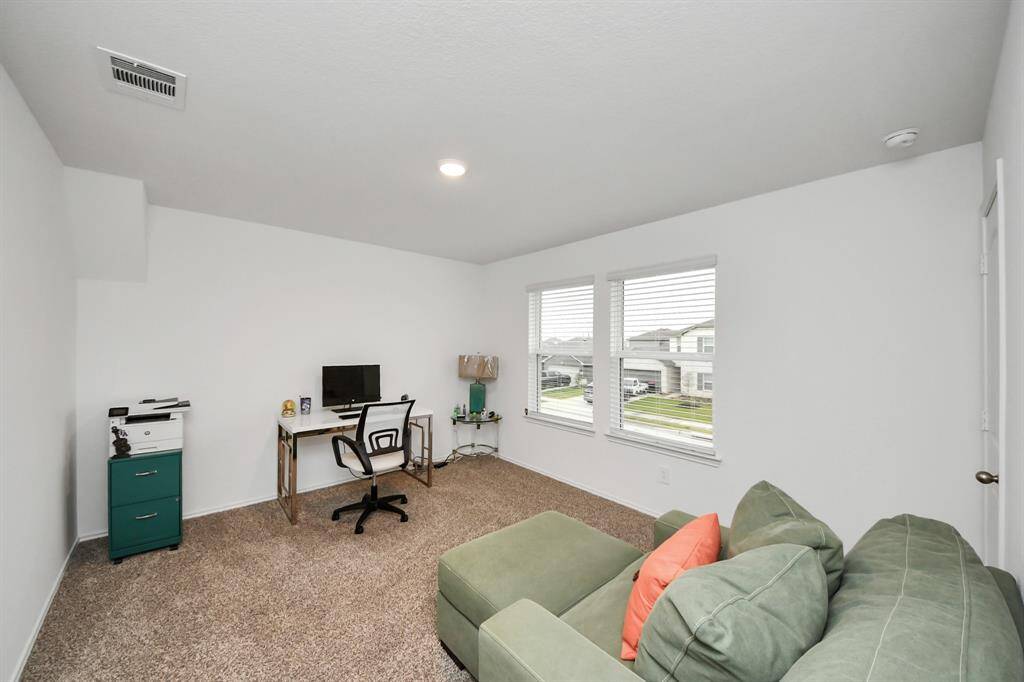 Spacious and versatile 4thbedroom with abundant natural light, perfect for a home office or guest room.