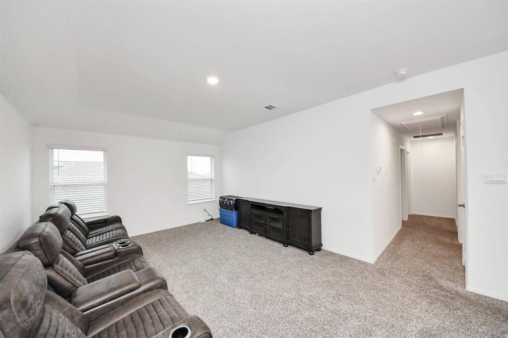Spacious upstairs game room perfect for entertainment and relaxation.