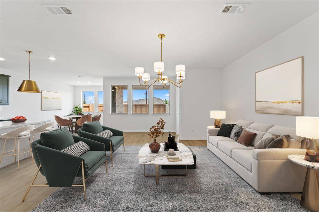 This light and bright kitchen features a large quartz island, custom painted cabinets, a large sink overlooking your family room, recessed lighting, and beautiful backsplash.