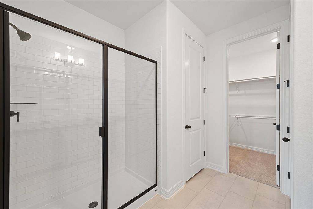 The covered patio is generously sized, providing ample space for various outdoor activities.