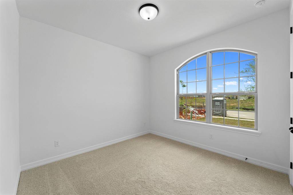 Your secondary bedroom features plush carpet, fresh paint, closet, and a large window that lets in plenty of natural lighting.