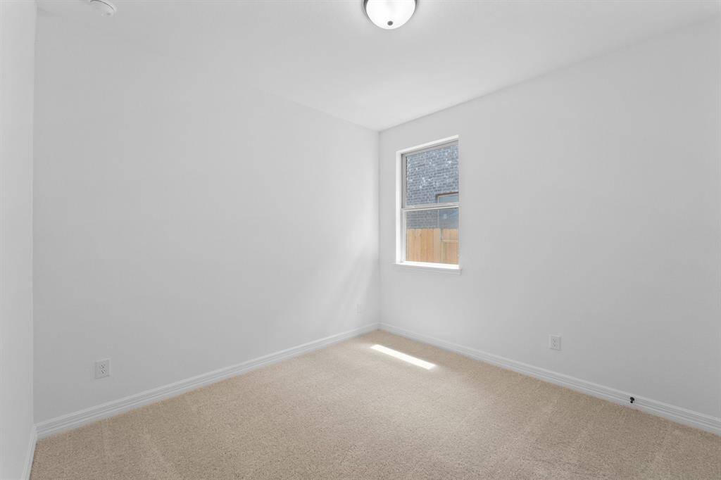 Your secondary bedroom features plush carpet, fresh paint, closet, and a large window that lets in plenty of natural lighting.