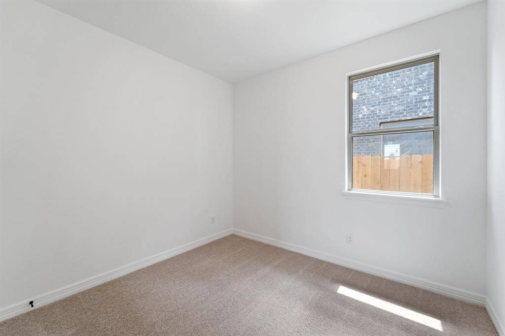 Your secondary bedroom features plush carpet, fresh paint, closet, and a large window that lets in plenty of natural lighting.