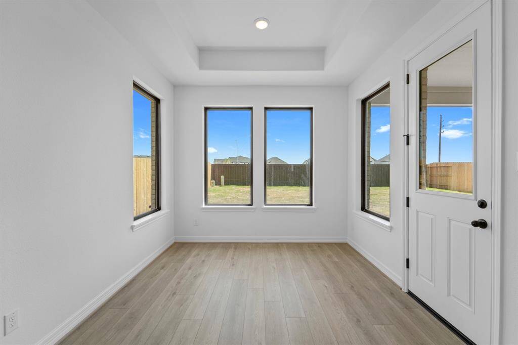With an abundance of natural light streaming through the windows, the breakfast nook is bathed in a sunny glow, creating the perfect atmosphere to enjoy your morning coffee or a family breakfast.