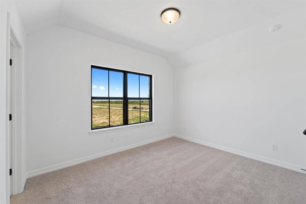 Your secondary bedroom features plush carpet, fresh paint, closet, and a large window that lets in plenty of natural lighting.