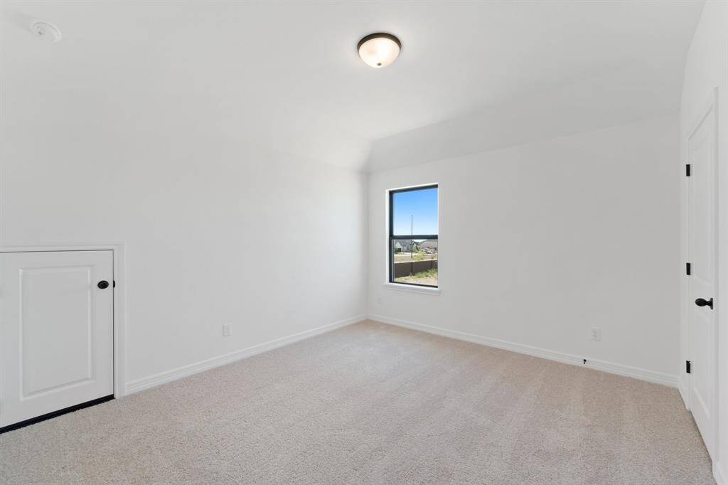 Your secondary bedroom features plush carpet, fresh paint, closet, and a large window that lets in plenty of natural lighting.