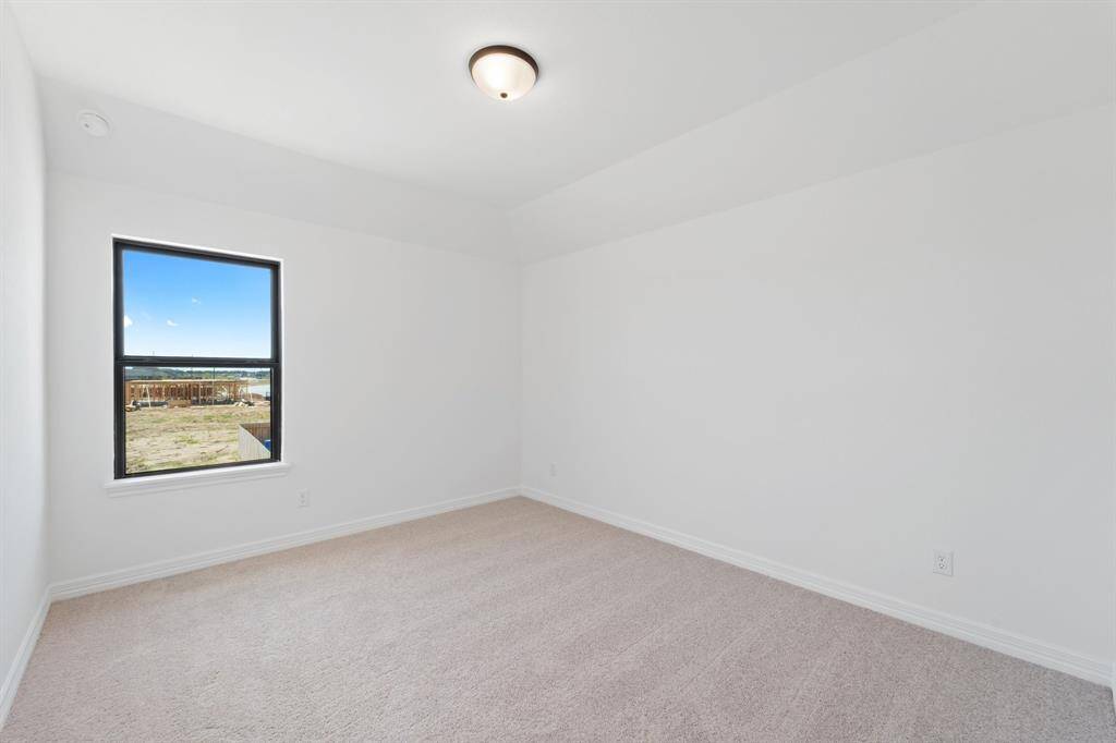 Your secondary bedroom features plush carpet, fresh paint, closet, and a large window that lets in plenty of natural lighting.