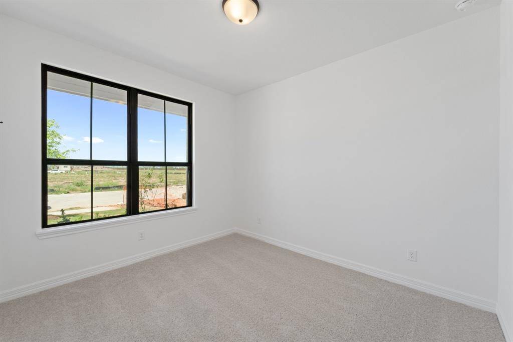 Your secondary bedroom features plush carpet, fresh paint, closet, and a large window that lets in plenty of natural lighting.