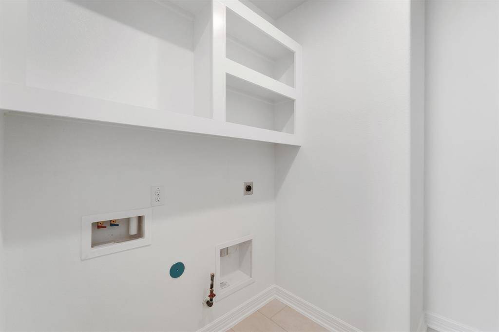 The laundry room layout is carefully planned for optimal workflow with designated areas for washing, drying, and storing.